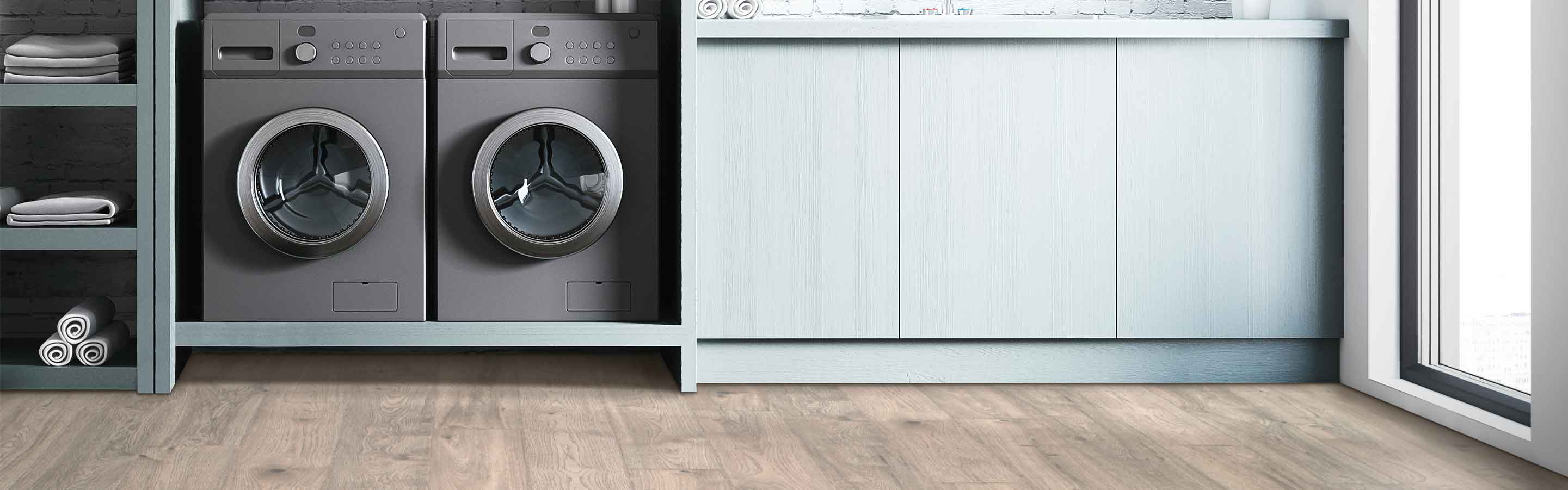 wood-look laminate flooring in modern laundry room with gray washer and dryer